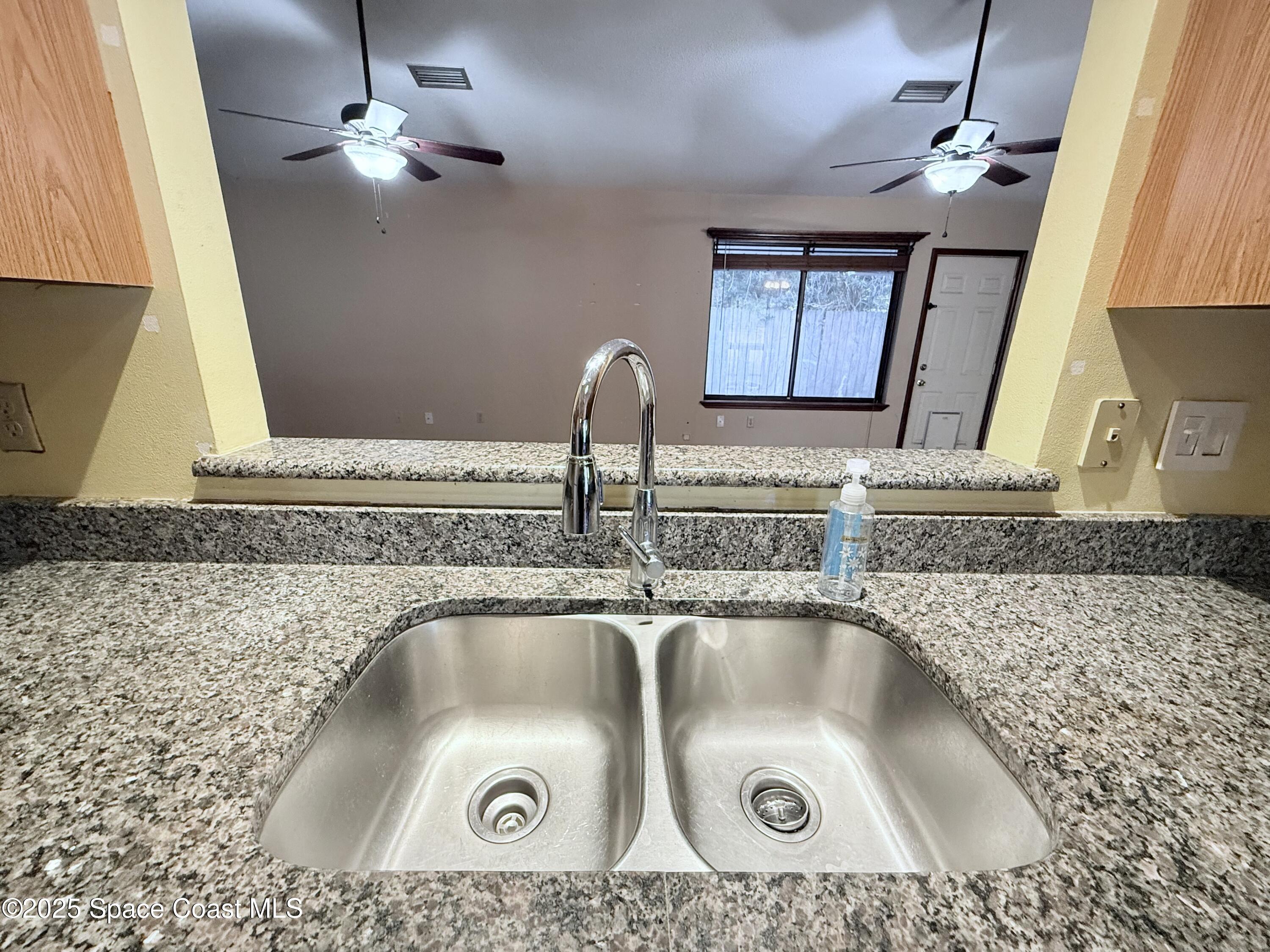 6180 Balboa Street Cocoa, FL 32927 - Photo 17 of 44 a kitchen with a sink a counter top space and cabinets