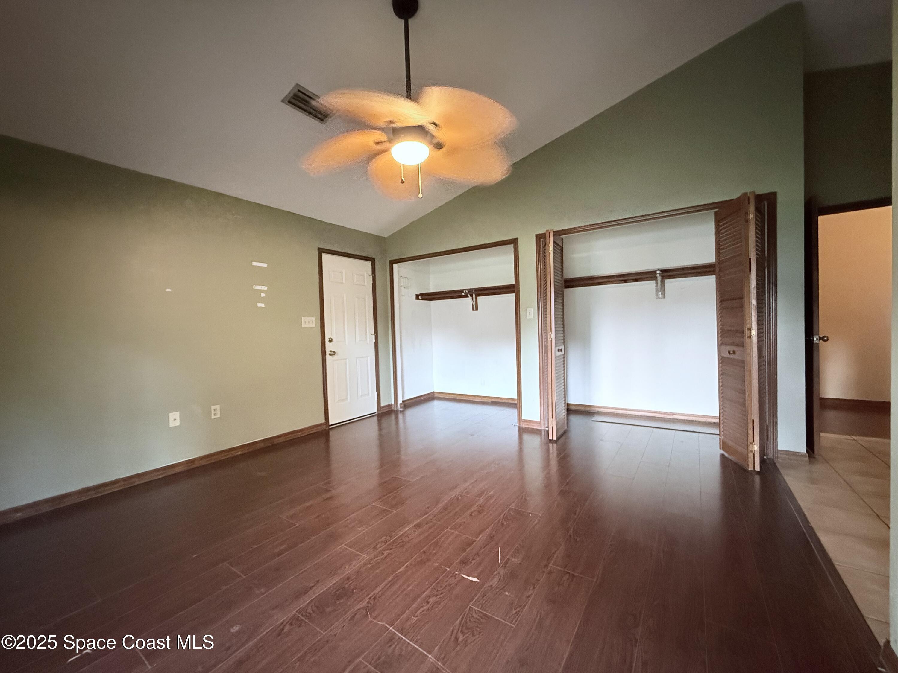 6180 Balboa Street Cocoa, FL 32927 - Photo 19 of 44 a view of an empty room with wooden floor and a window