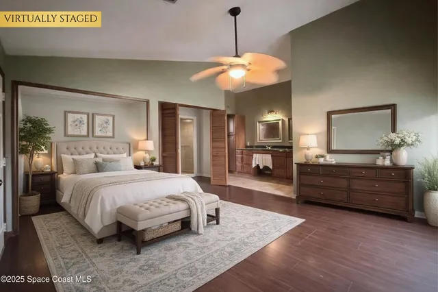 a spacious bedroom with a large bed and a chandelier
