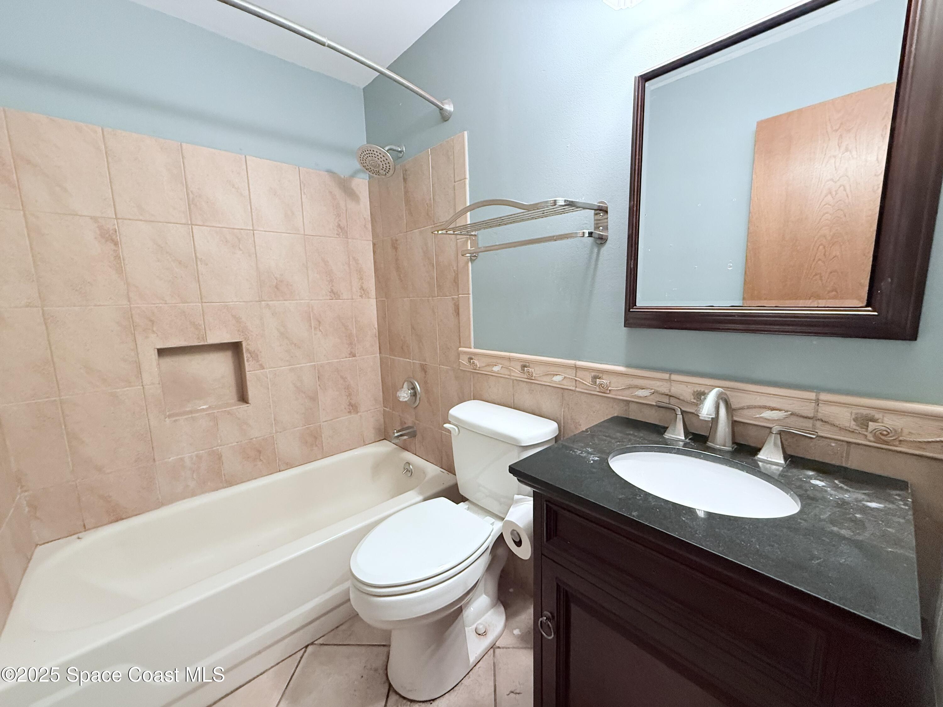 6180 Balboa Street Cocoa, FL 32927 - Photo 26 of 44 a bathroom with a sink a toilet and shower