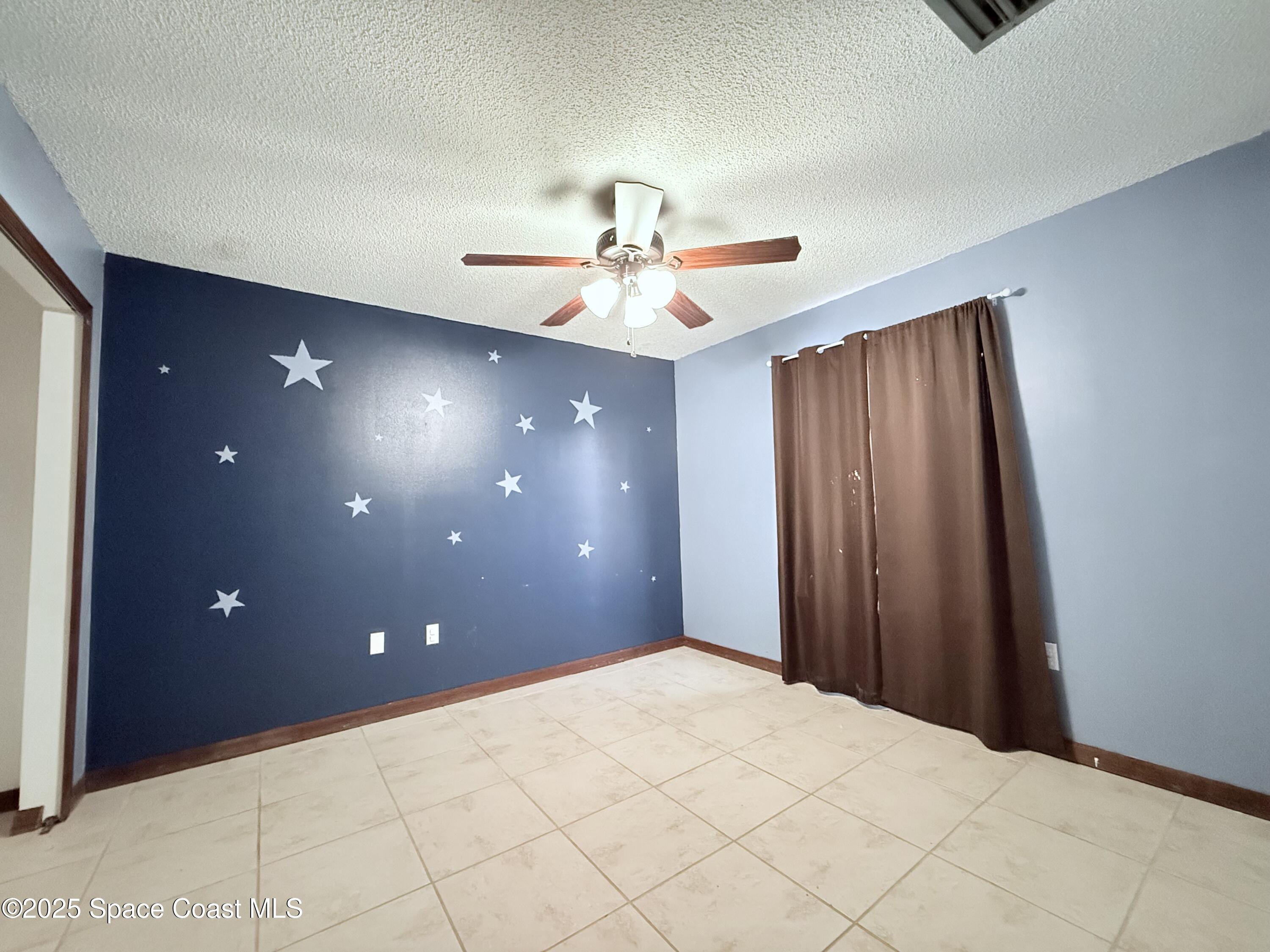 6180 Balboa Street Cocoa, FL 32927 - Photo 28 of 44 a view of a livingroom with a ceiling fan and window