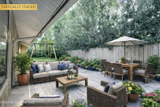 a backyard of a house with outdoor seating