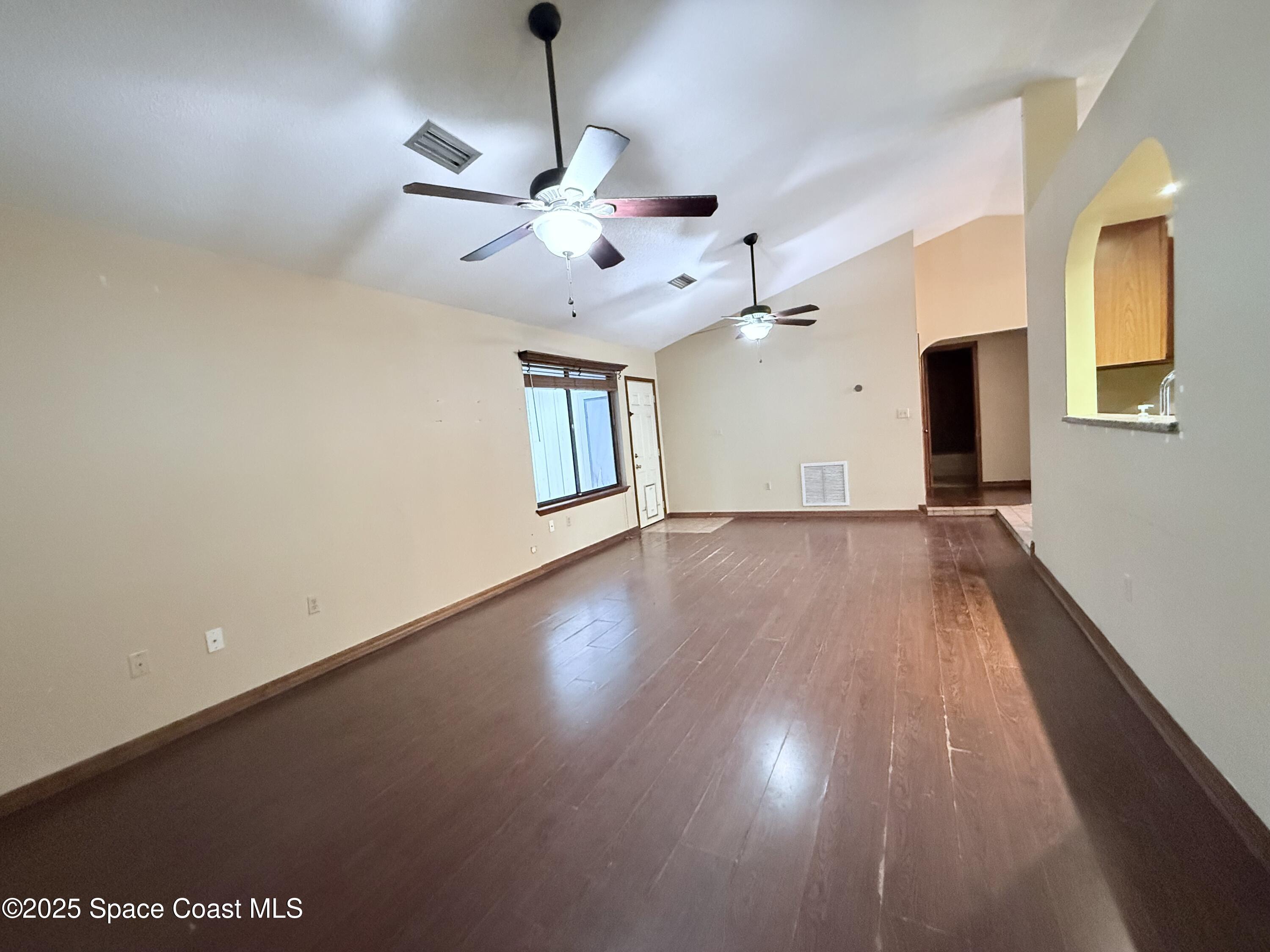 6180 Balboa Street Cocoa, FL 32927 - Photo 8 of 44 a view of an empty room with wooden floor and a window