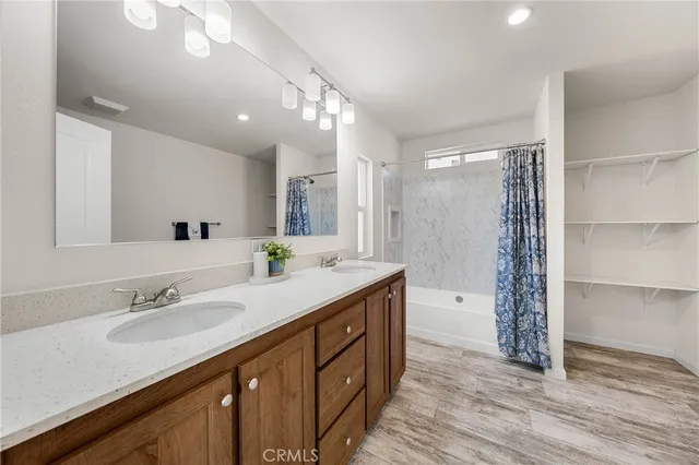 a bathroom with a sink double vanity and a shower
