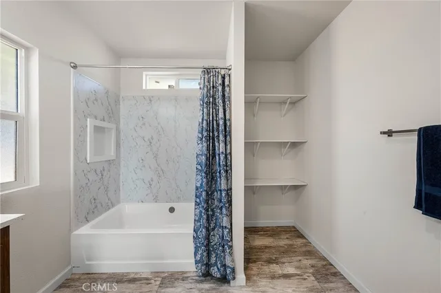a bathroom with a bathtub and a shower