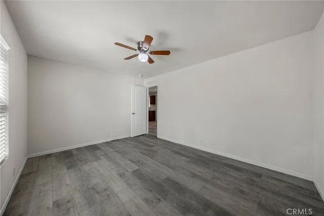 a view of room with hardwood floor and ceiling fan