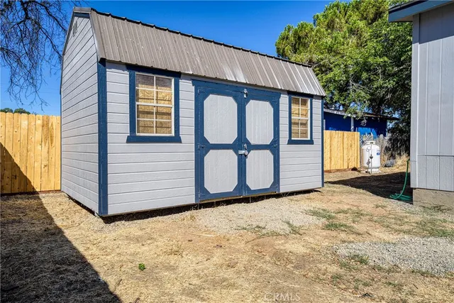 a view of a house with wooden fence