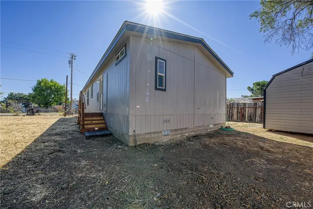 a view of a house with backyard and trees