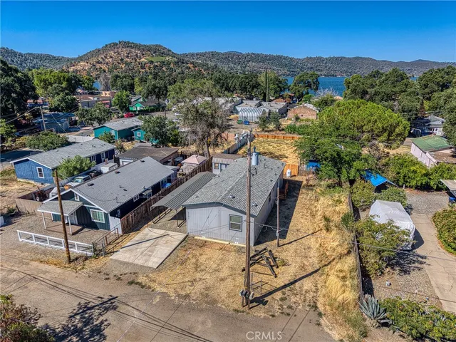 an aerial view of a house with a mountain in the background