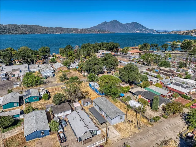 an aerial view of residential house with outdoor space and lake view