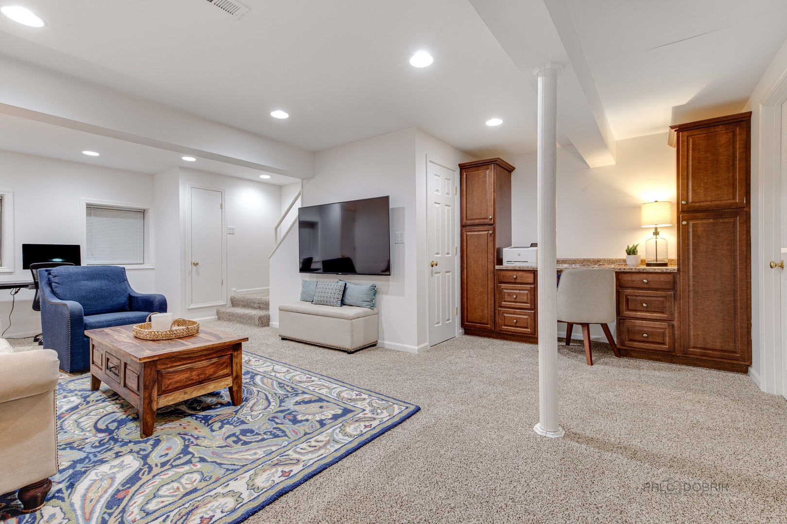 801 Hibbard Road Wilmette, IL 60091 - Photo 24 of 28 a living room with furniture and a flat screen tv
