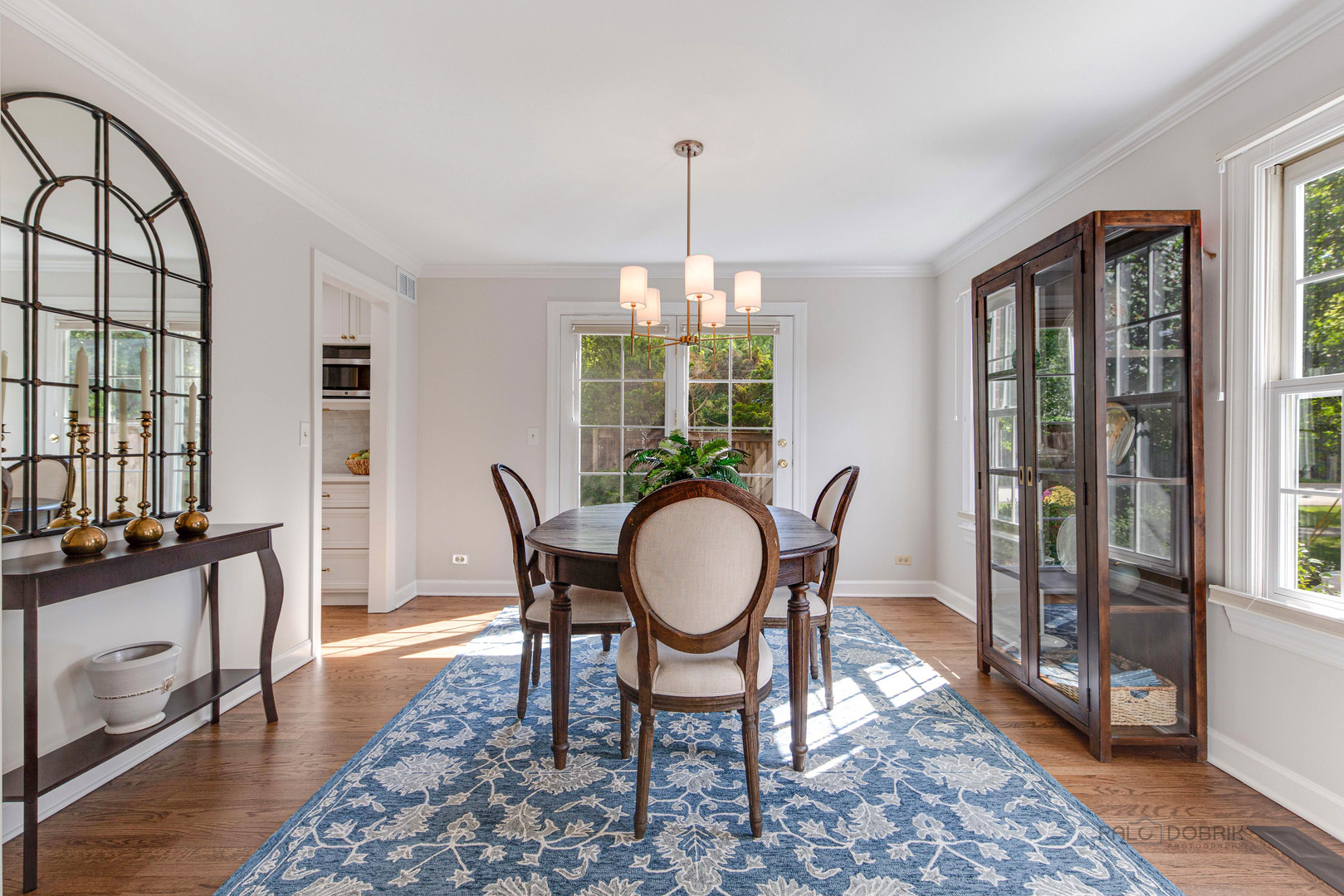 801 Hibbard Road Wilmette, IL 60091 - Photo 5 of 28 a dining room with furniture a rug a potted plant and a chandelier