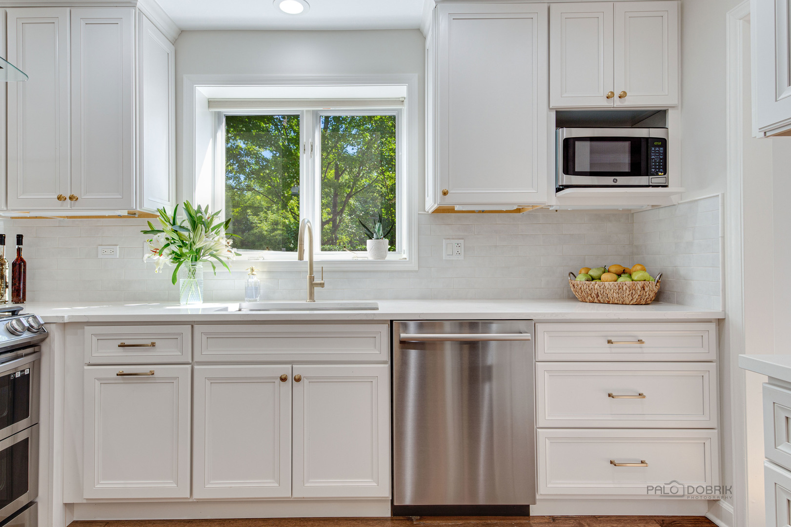 801 Hibbard Road Wilmette, IL 60091 - Photo 8 of 28 a kitchen with white cabinets and a window