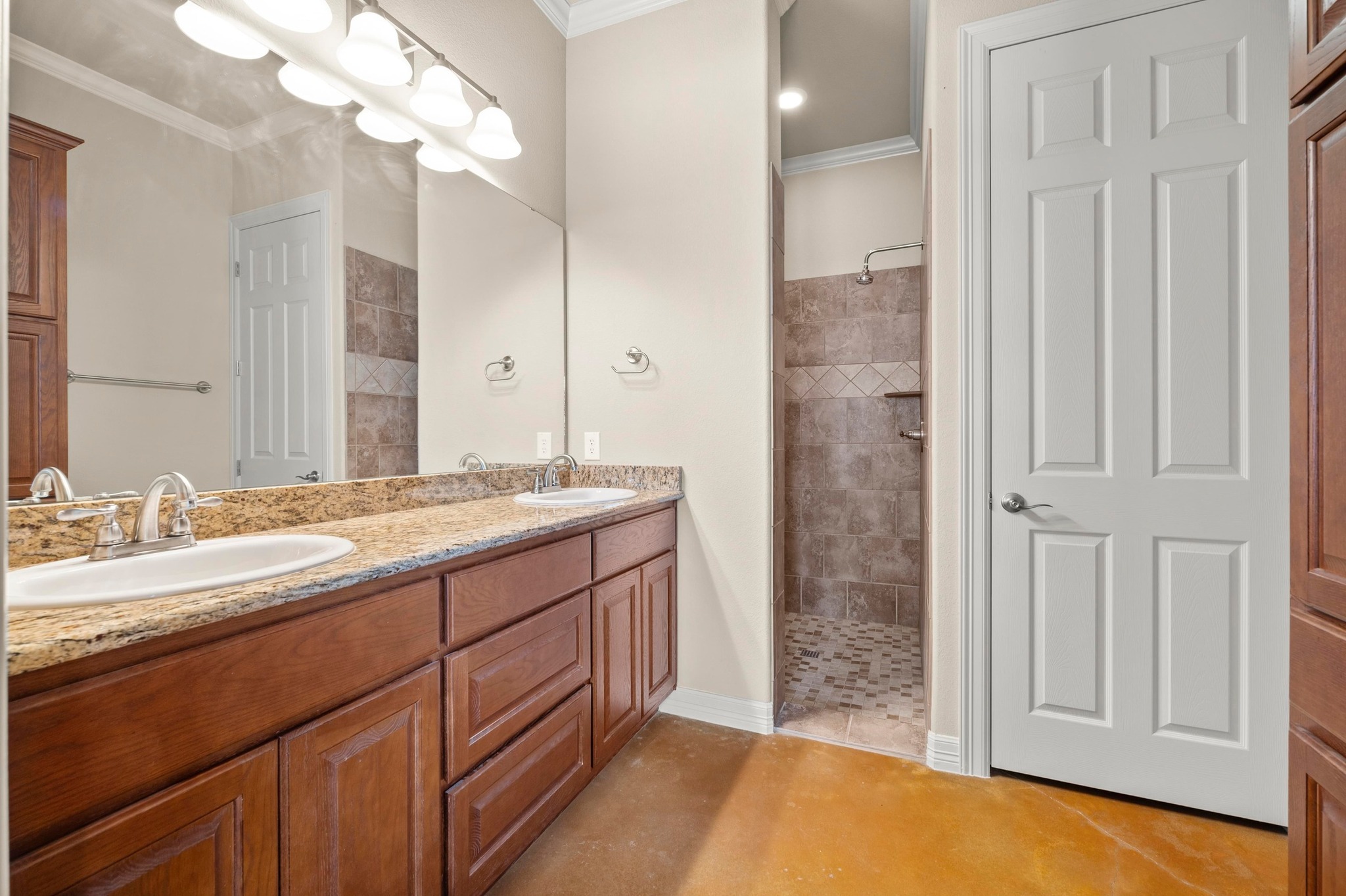 28701 Valley Road Marble Falls, TX 78654 - Photo 17 of 35 a bathroom with a granite countertop sink a mirror and a shower