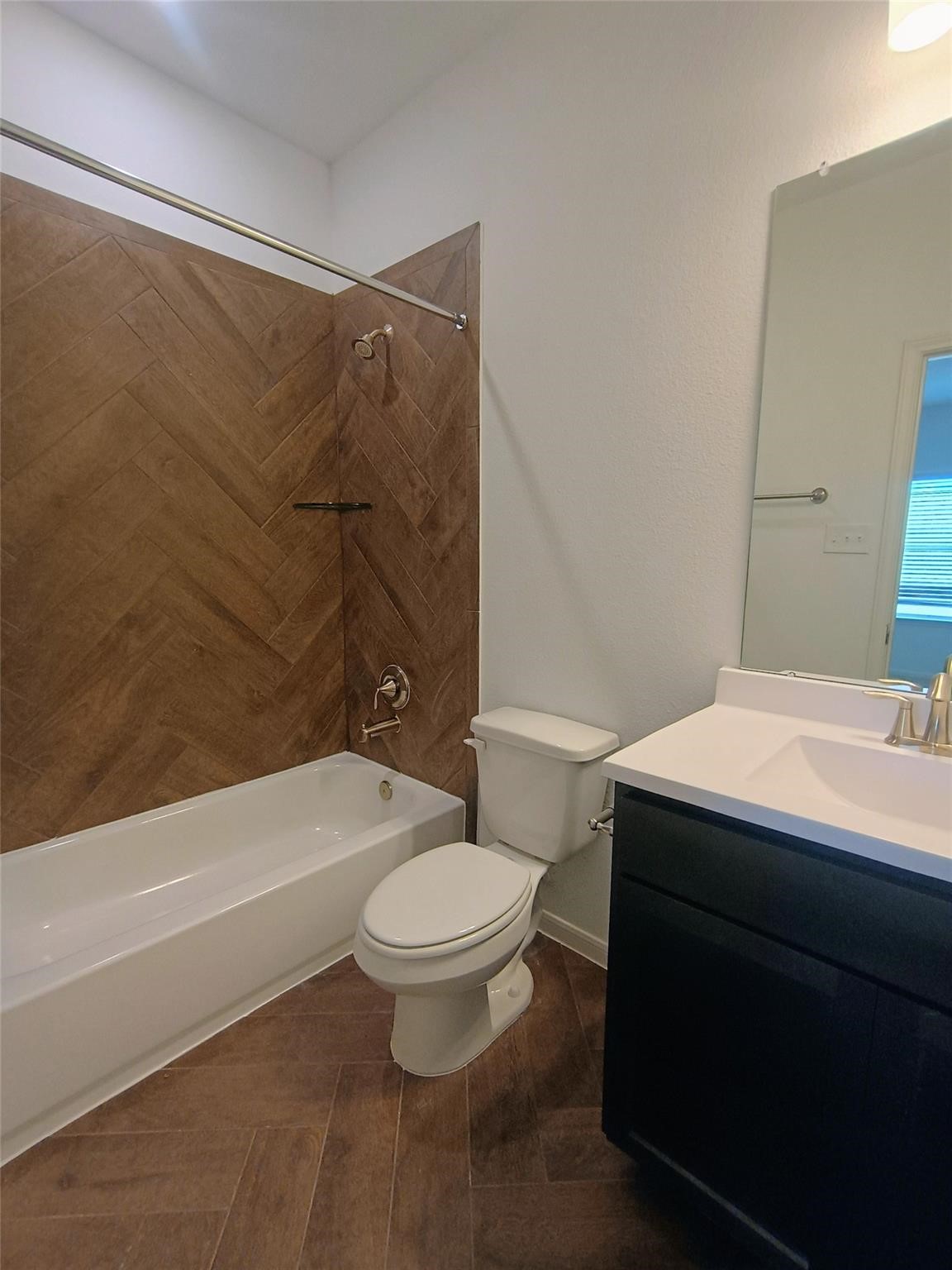 15924 Cy Young Court Splendora, TX 77372 - Photo 19 of 29 a bathroom with a sink a toilet and a bathtub