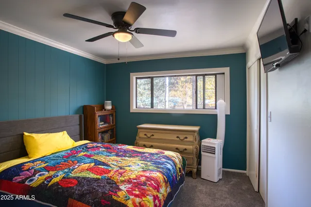 a bedroom with a bed and a tv