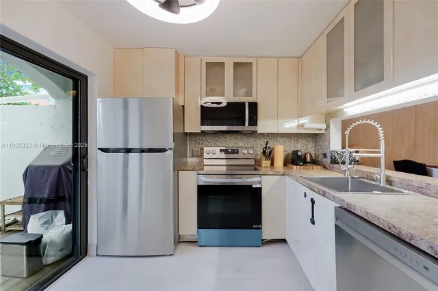 a kitchen with a refrigerator stove and sink