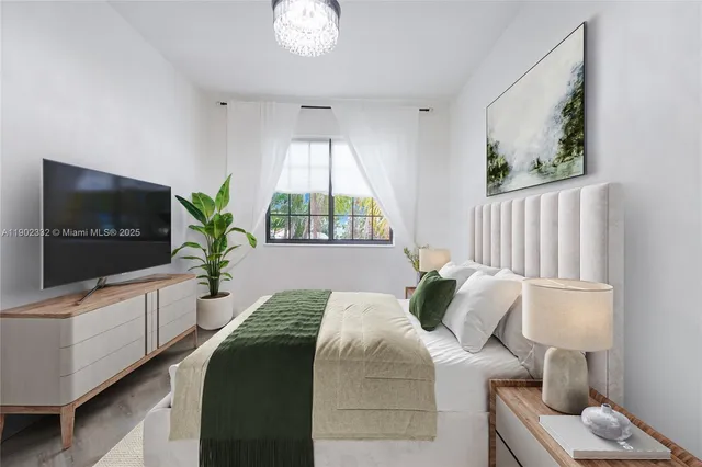 a bedroom with a bed and a flat screen tv