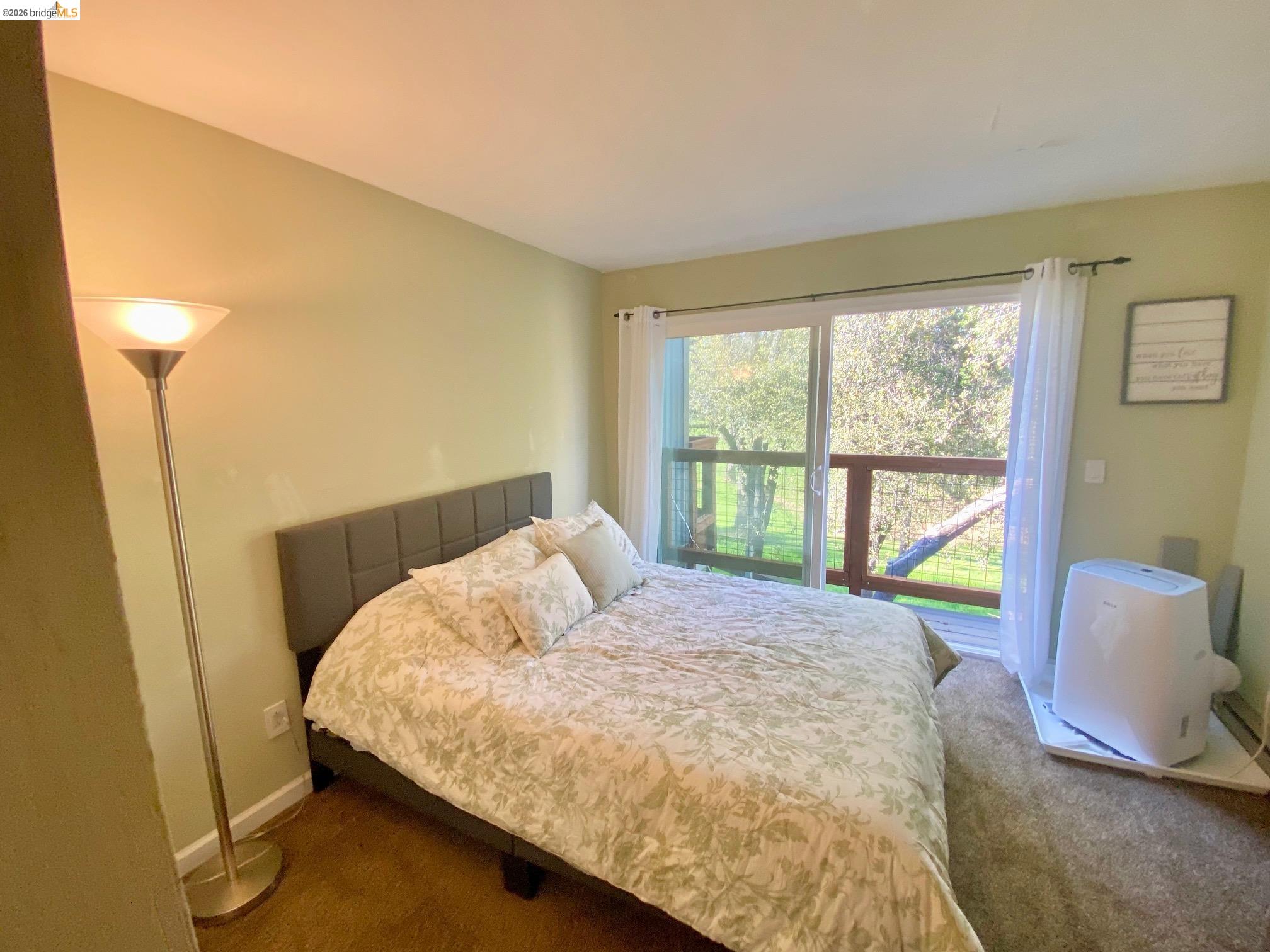 19096 Dyer Court, Unit 2 Groveland, CA 95321 - Photo 18 of 46 a bedroom with a bed and a window