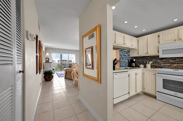 a kitchen with stainless steel appliances a refrigerator sink and cabinets
