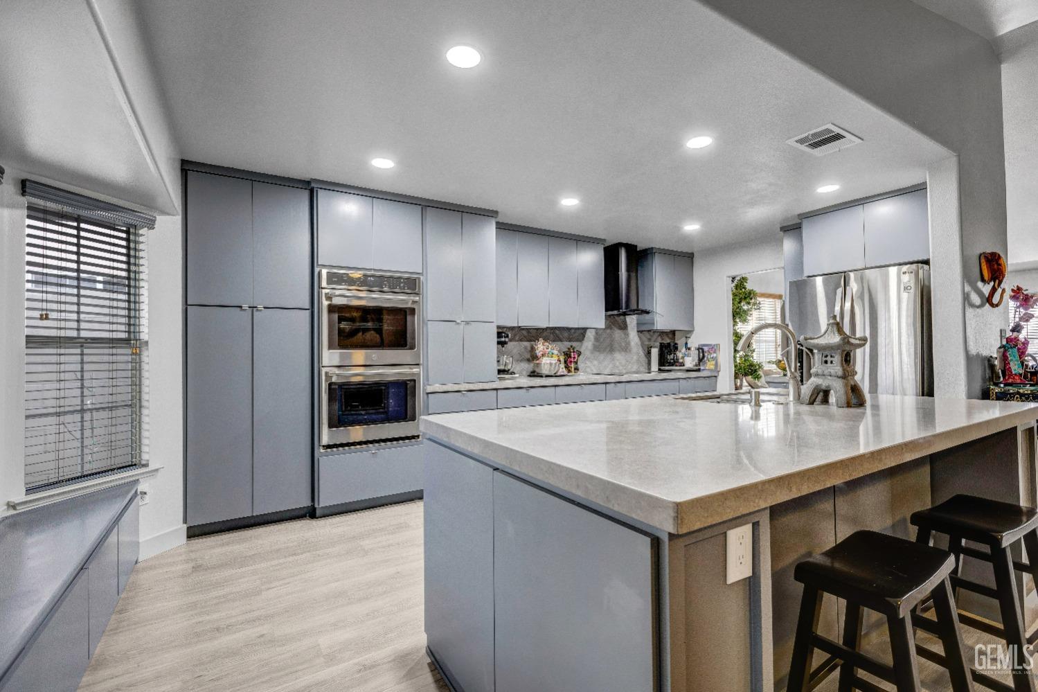 Undisclosed Address Delano, CA 93215 - Photo 11 of 40 a kitchen with a center island appliances and cabinets