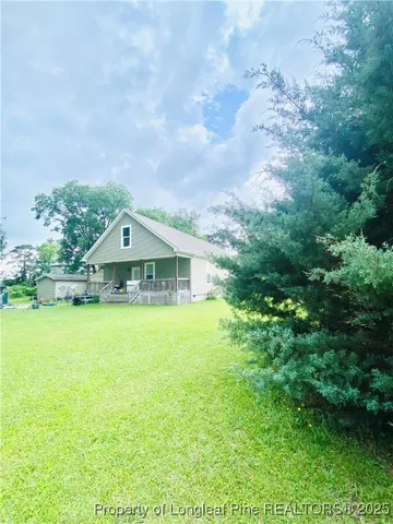 a view of house with garden and deck