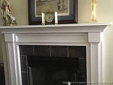 a view of a hallway with a fireplace and a mirror