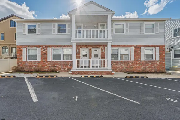 a view of a brick house with large windows