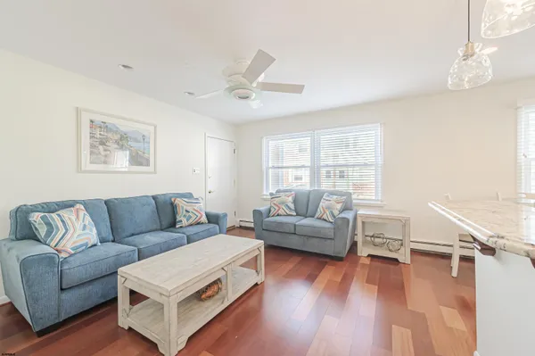 a kitchen with stainless steel appliances granite countertop a refrigerator a stove a sink and white cabinets