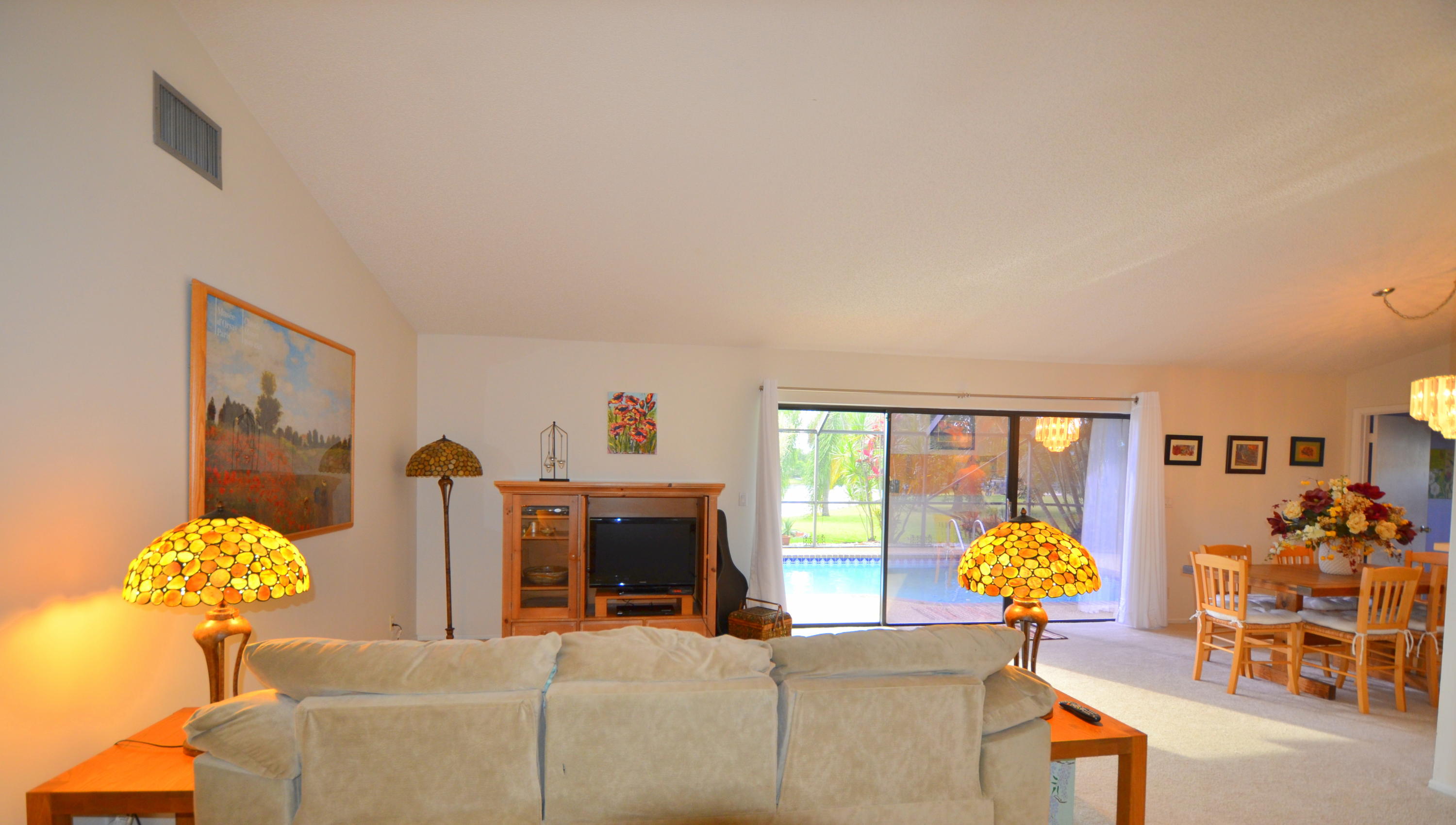 9539 Silverspring Lane Boca Raton, FL 33434 - Photo 12 of 28 a living room with furniture and chandelier