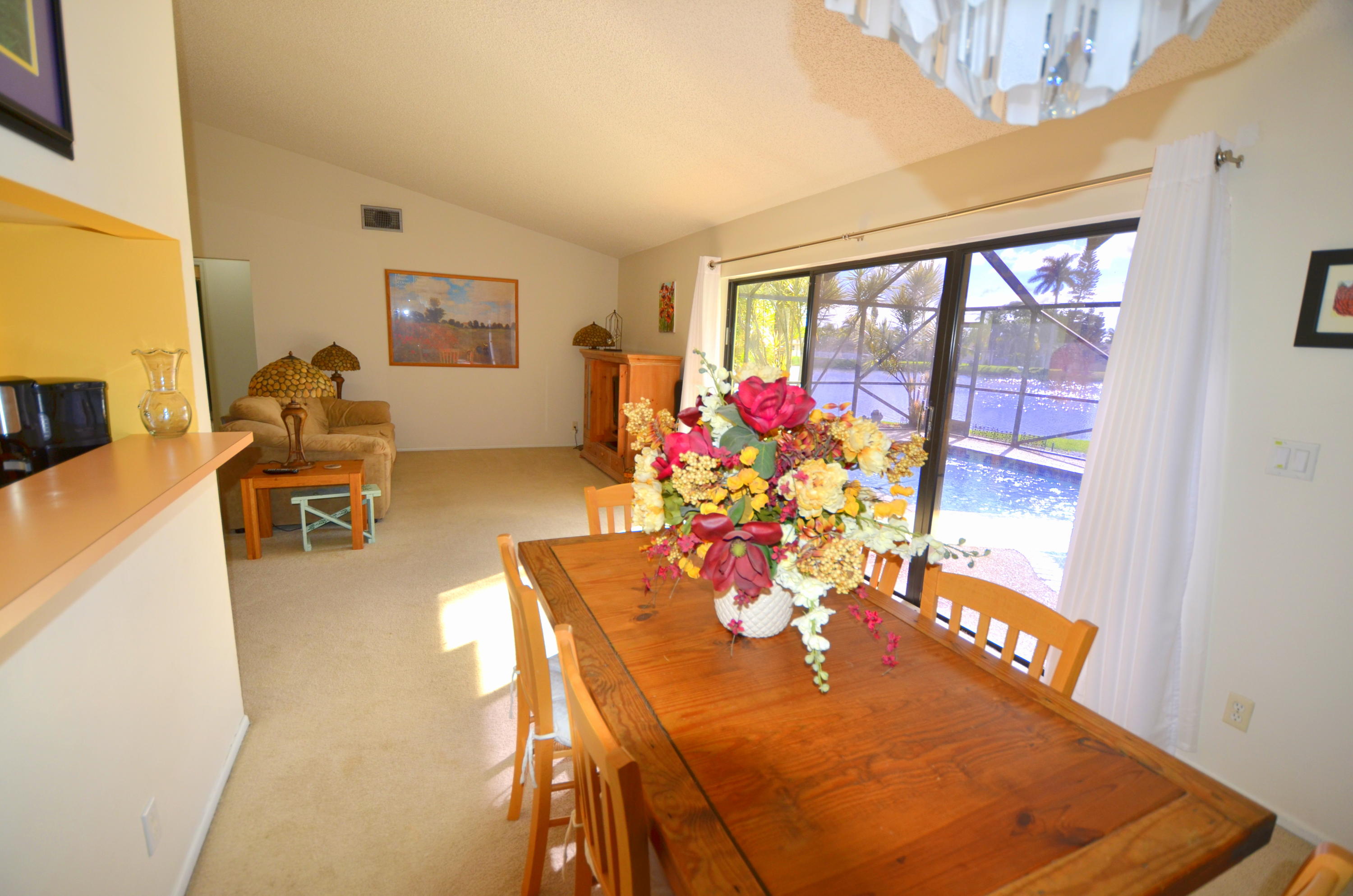 9539 Silverspring Lane Boca Raton, FL 33434 - Photo 13 of 28 a living room with dining table furniture and a floor to ceiling window