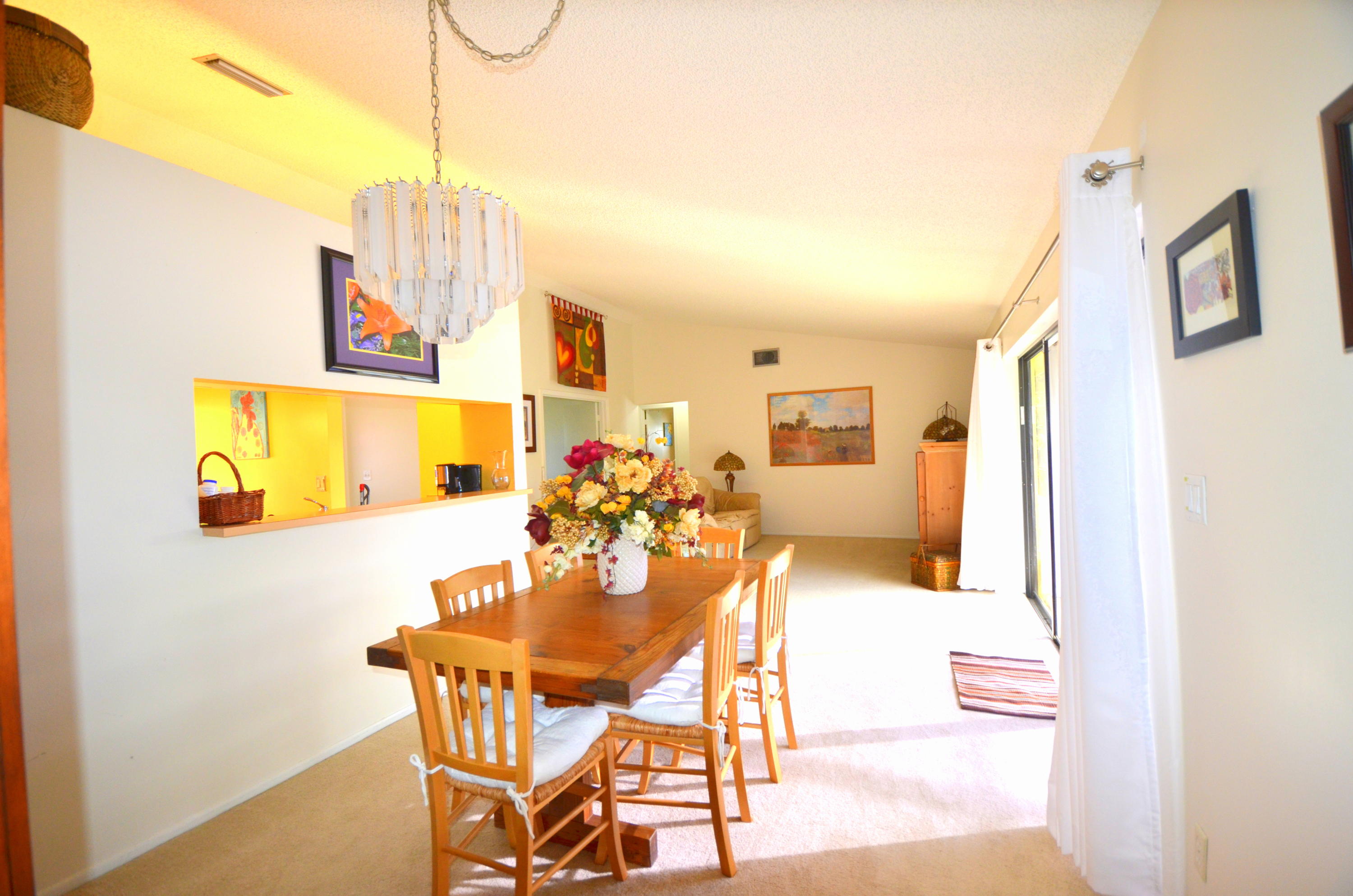 9539 Silverspring Lane Boca Raton, FL 33434 - Photo 14 of 28 a view of a dining room with furniture and chandelier
