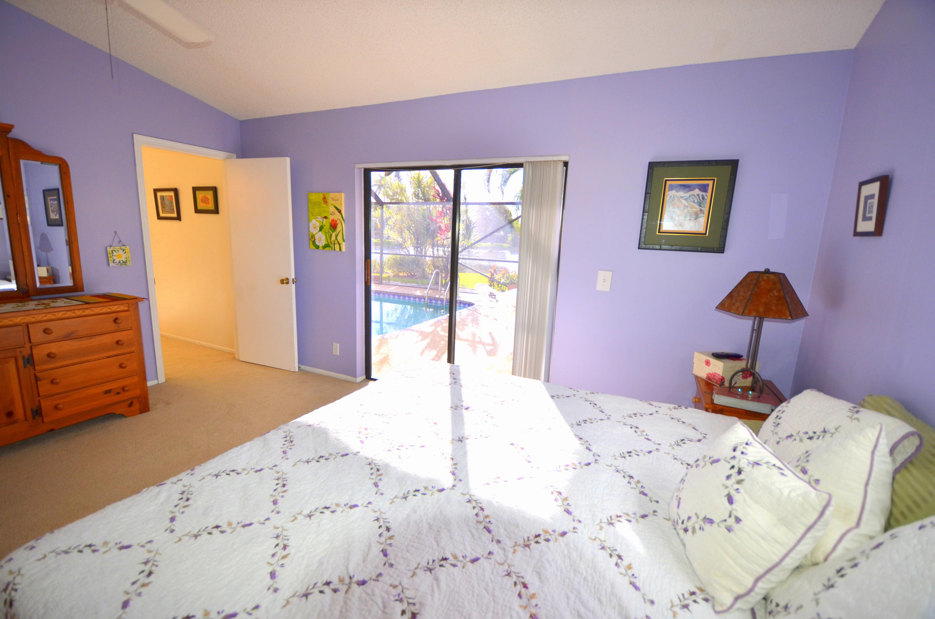 9539 Silverspring Lane Boca Raton, FL 33434 - Photo 16 of 28 a bedroom with a bed and dresser with mirror