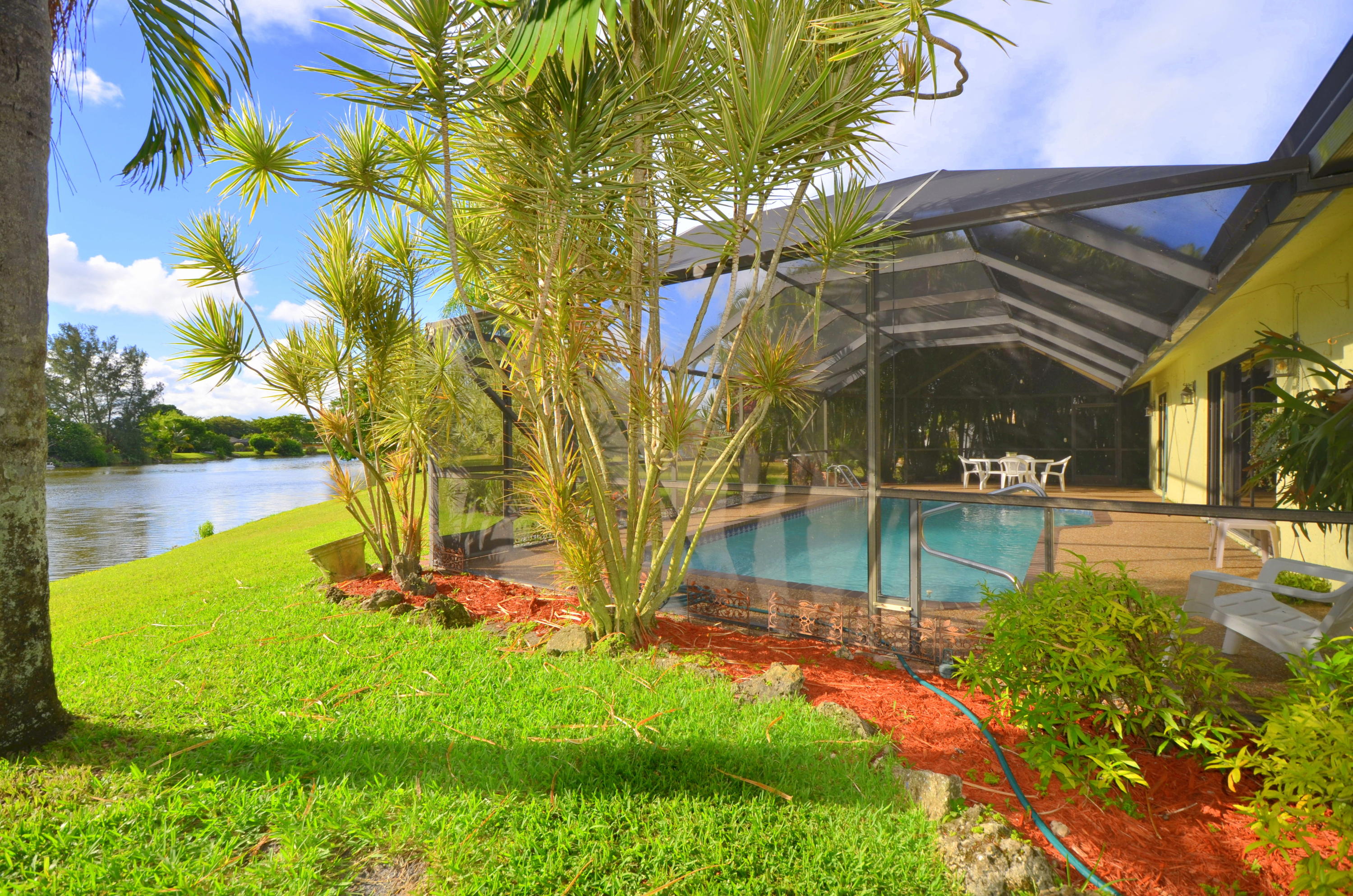 9539 Silverspring Lane Boca Raton, FL 33434 - Photo 21 of 28 a view of a backyard with swimming pool