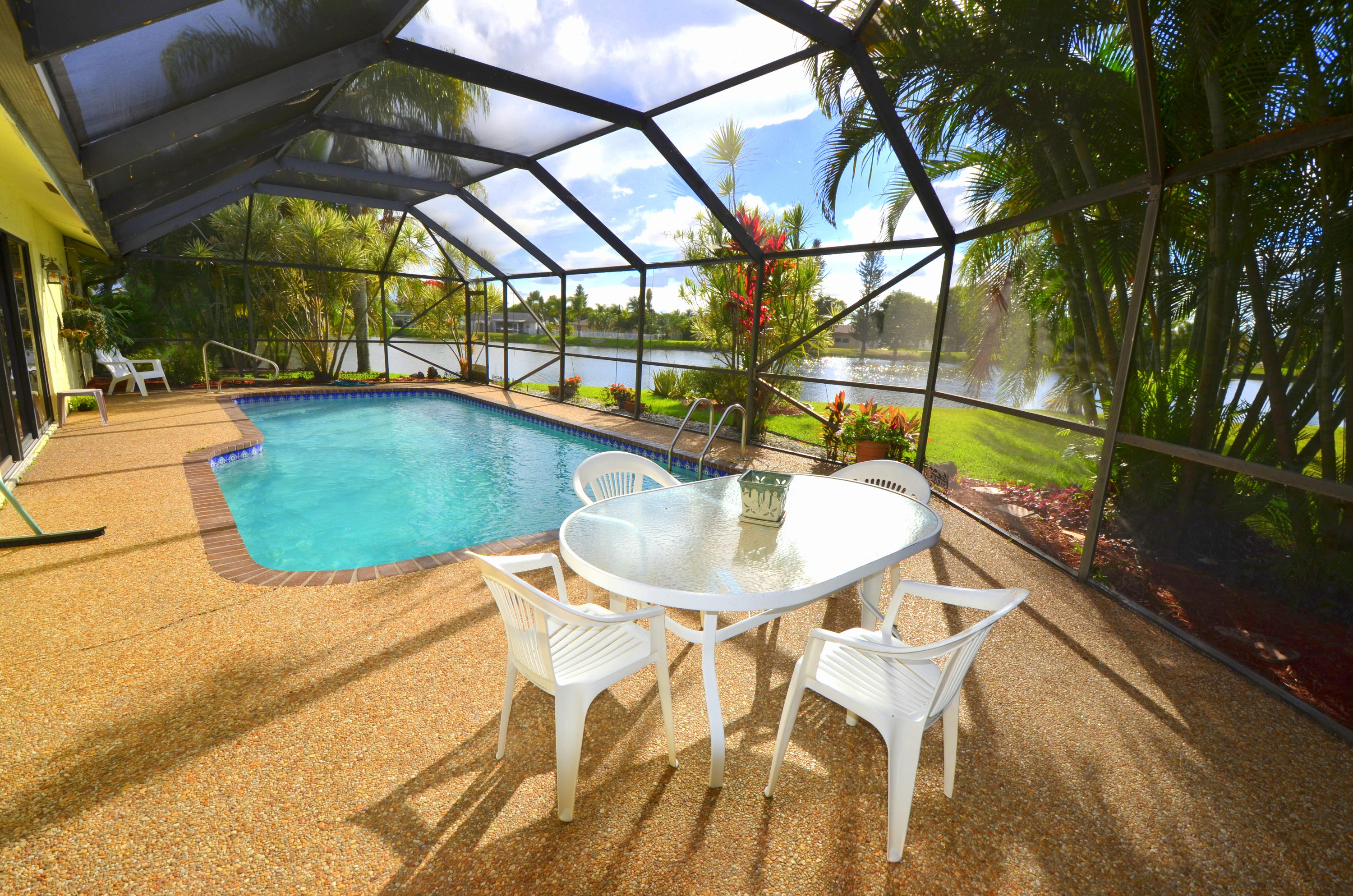9539 Silverspring Lane Boca Raton, FL 33434 - Photo 22 of 28 a view of an outdoor space and swimming pool