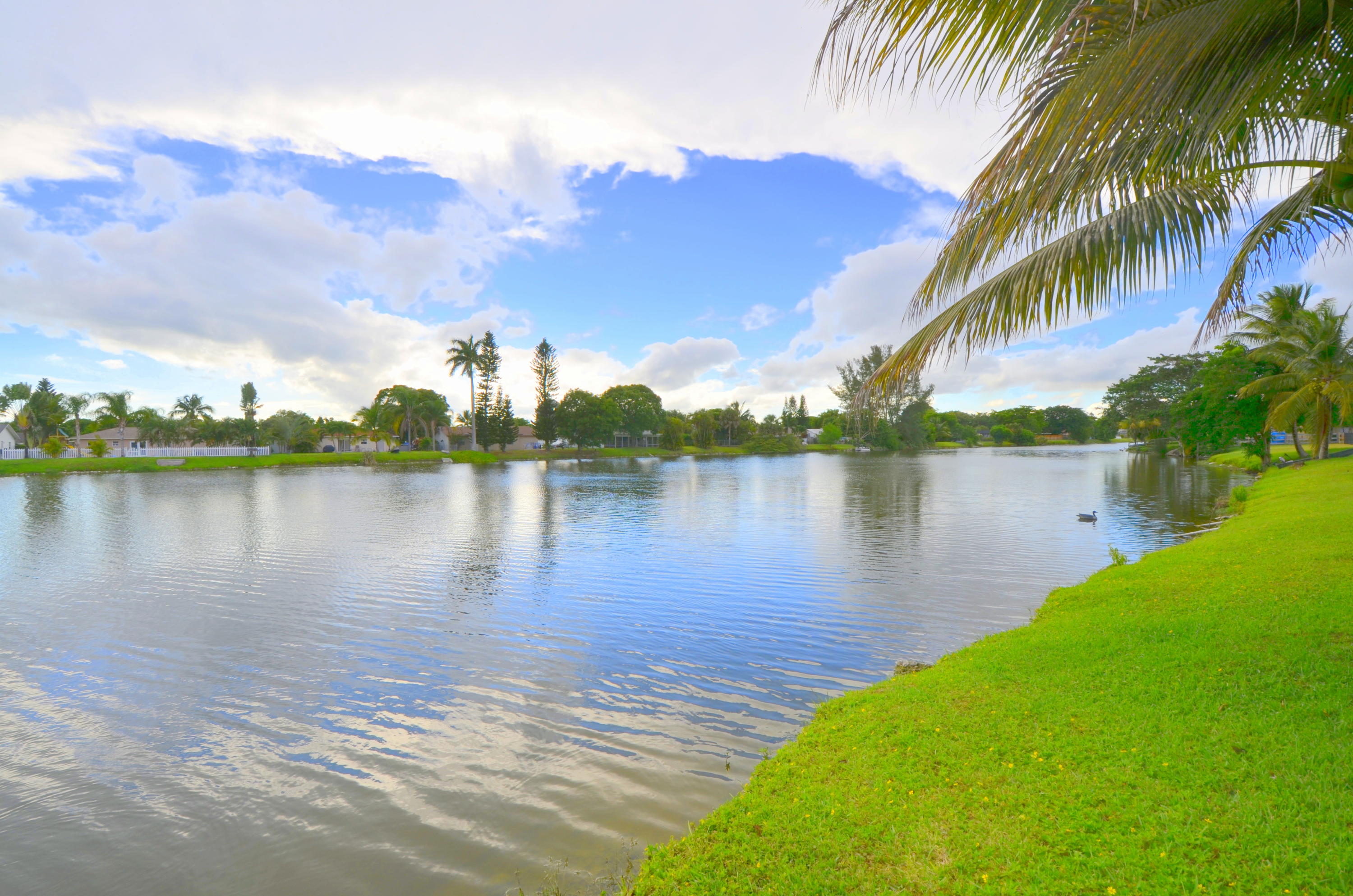 9539 Silverspring Lane Boca Raton, FL 33434 - Photo 23 of 28 a view of a lake with houses in the back