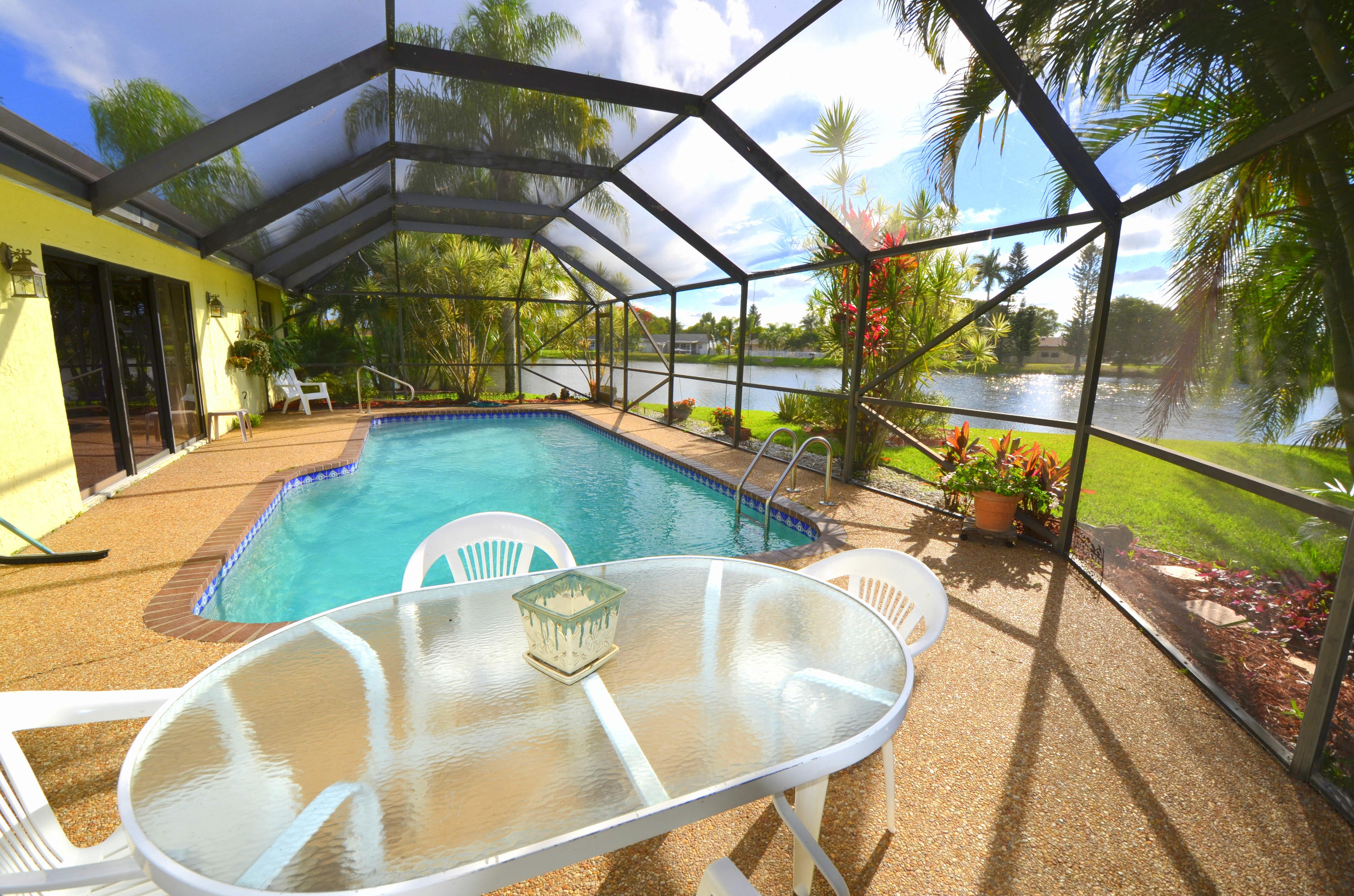 9539 Silverspring Lane Boca Raton, FL 33434 - Photo 5 of 28 a view of a swimming pool with a patio