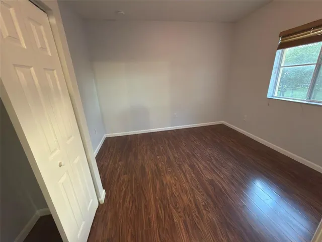 a view of a hallway in a house with wooden floor