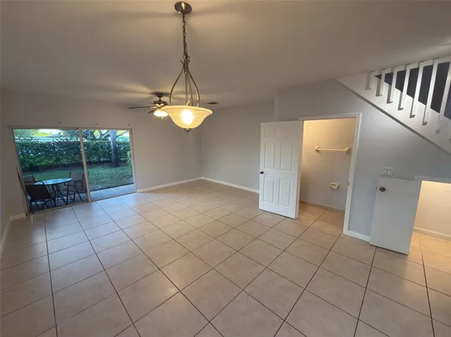 a view of a livingroom with furniture and chandelier fan