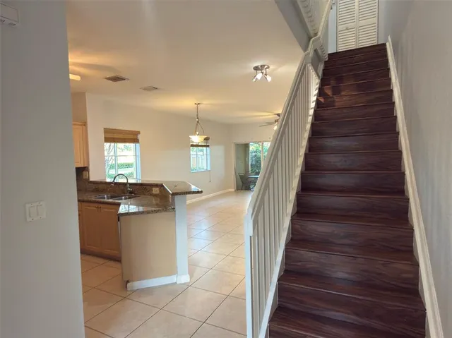 a view of entryway and hall with wooden floor
