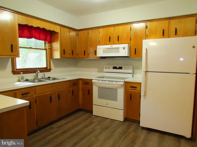 a kitchen with a refrigerator and a sink