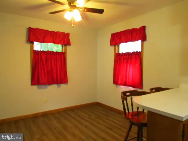 a view of a room with furniture and chandelier