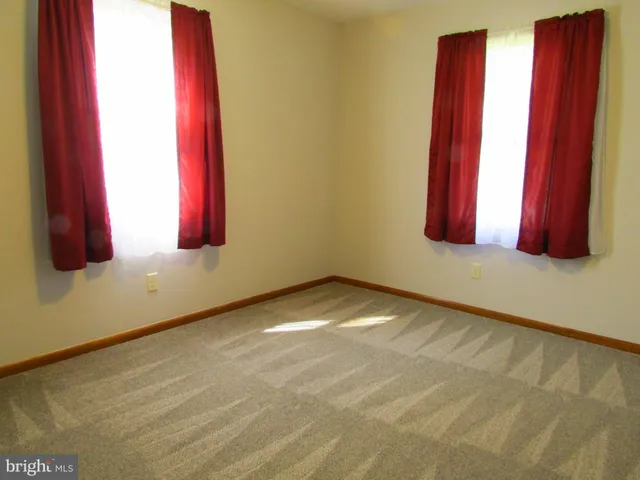 a view of a room with a window and a bed