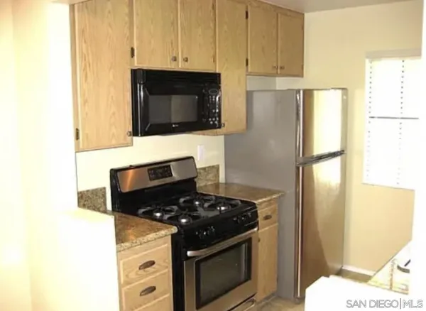 a kitchen with a stove and a microwave