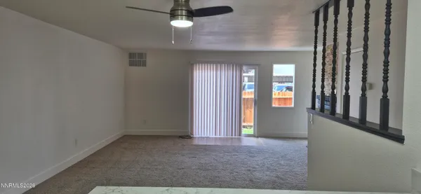 an empty room with windows and entrance