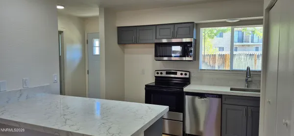 a kitchen with a stove and a microwave