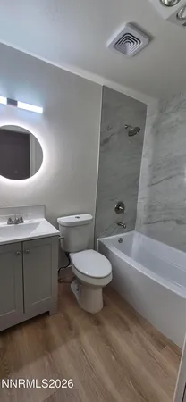 a bathroom with a toilet a sink and bathtub