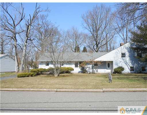 8 Nottingham Road Edison, NJ 08820 - Photo 1 of 15 a view of a house with a yard covered with snow in the background