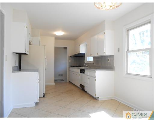 8 Nottingham Road Edison, NJ 08820 - Photo 4 of 15 a kitchen with stainless steel appliances kitchen island granite countertop a refrigerator and a stove top oven