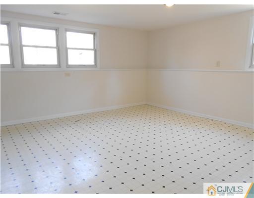 8 Nottingham Road Edison, NJ 08820 - Photo 6 of 15 a big room with wooden floor